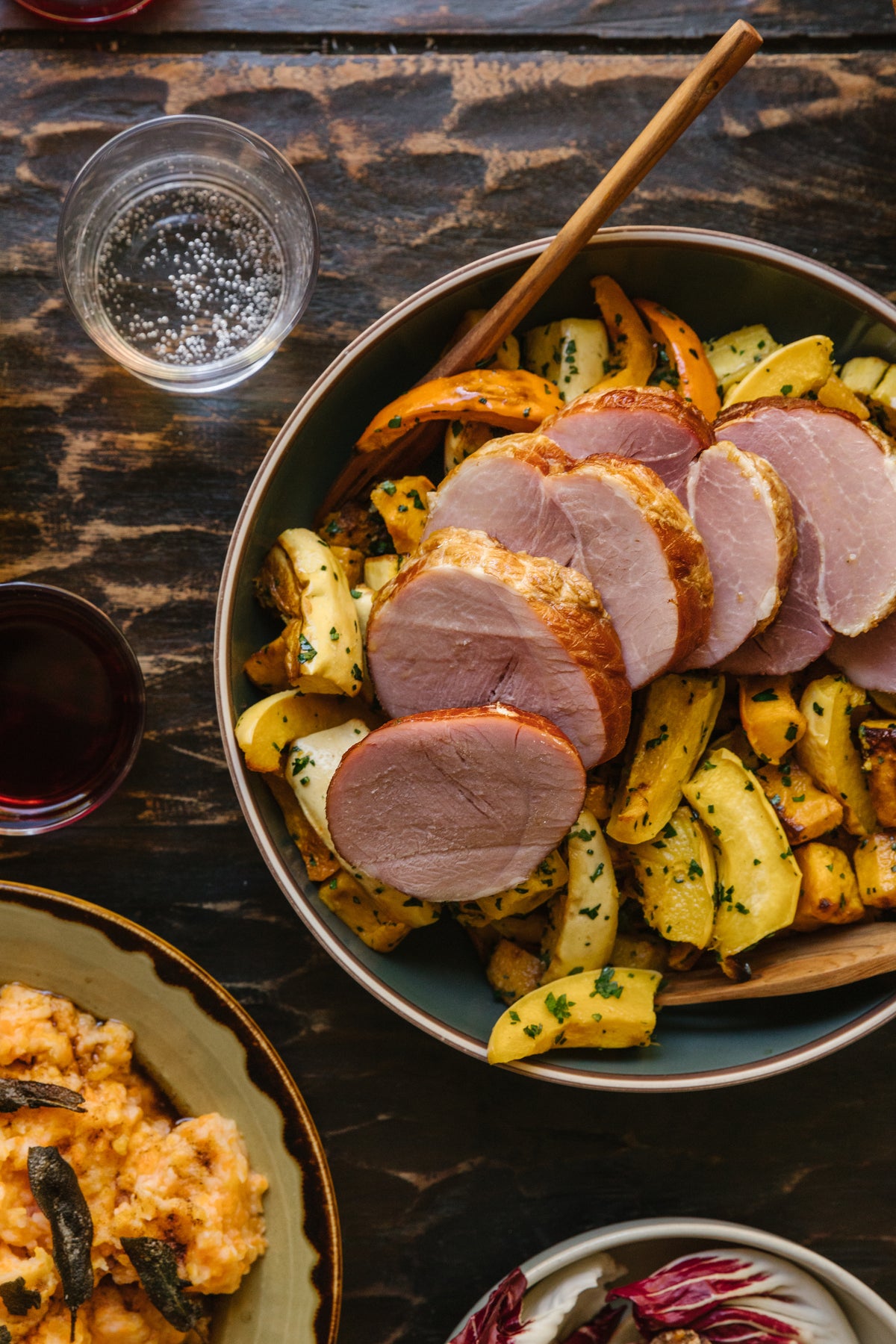 Ham on a bed of squash in a frying pan 